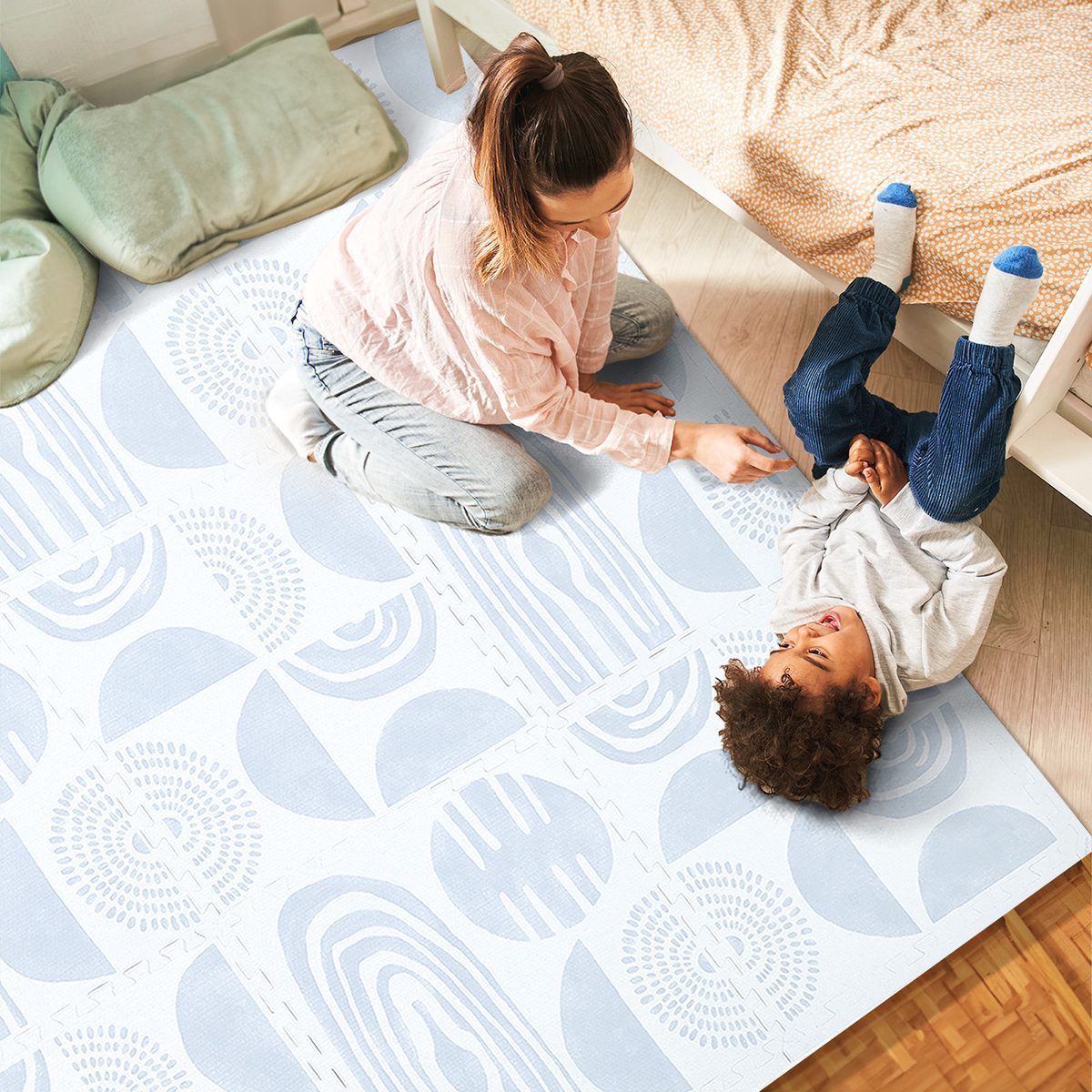 Family relaxing on a PopsyKosy play mat in a bright living room